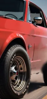 Mobile wallpaper of a classic red muscle car in motion.