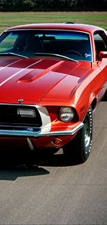 Classic red Mustang on open road wallpaper.