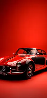 Classic red sports car on a vibrant red backdrop.