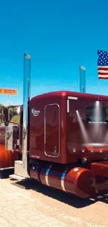 Classic red truck with American flag under blue sky.