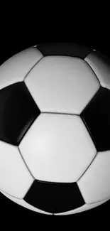 Black and white soccer ball on a dark background wallpaper.