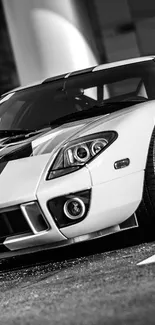 Black and white classic sports car parked outside.