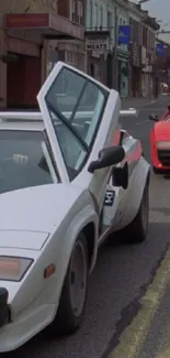 Classic white and red sports cars on urban street.