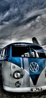 A classic van on a beach under a dramatic cloudy sky.