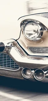 Close-up of a vintage car with chrome detailing in beige tones.