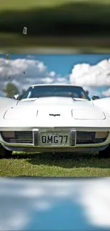 Front view of a classic white sports car on a sunny day.