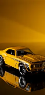 Vintage yellow car reflecting on a glossy surface against a matching backdrop.