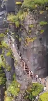 Cliffside pathway with rocks and greenery, perfect for adventure lovers.