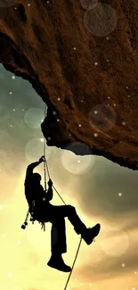 Silhouette of a rock climber against a sunset sky.