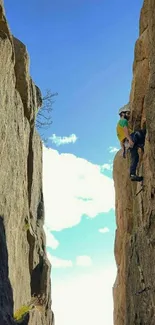 Rock climber ascending between large cliffs against a blue sky wallpaper.