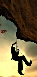 Man climbing rock with dragon, sunset background.