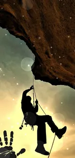 Silhouette of a climber on a rock face against a sunset sky.