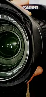 Close-up of a black camera lens focusing on intricate details.