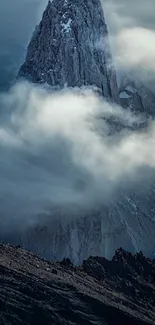 Majestic mountain peak surrounded by clouds.