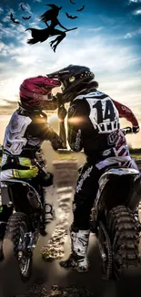 Two motocross riders under sunset sky with witch silhouette.