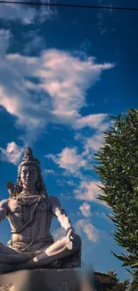 Shiva statue with blue sky background wallpaper.