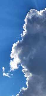 Luminous cloud with sunbeams against a vibrant blue sky wallpaper.