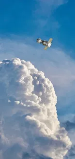 Satellite hovering over a fluffy cloud under a clear blue sky.