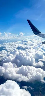 A view of fluffy white clouds below a vibrant blue sky with an airplane wing.