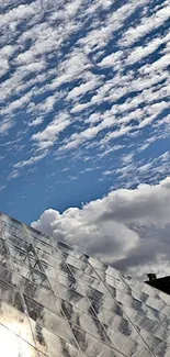 Glass pyramid beneath a vibrant cloudy sky.