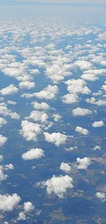 Aerial view of fluffy clouds in a serene blue sky, perfect for mobile wallpaper.