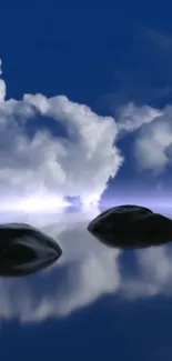 Serene clouds and dark rocks on reflective water.