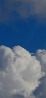 Fluffy white clouds against a clear blue sky on a mobile wallpaper.