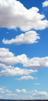 Serene sky with clouds over an open field.