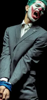 Clown in a suit strikes a dramatic pose against a dark background.