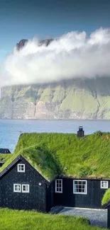 Coastal cabin with grassy rooftops and sea view.