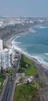 Aerial view of a coastal city with ocean waves and urban skyline.