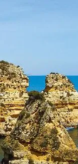 Scenic coastal view with blue ocean and rocky cliffs.