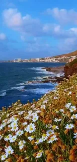 Coastal landscape with daisies and ocean waves under a blue sky.