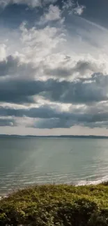 Scenic coastal view with ocean and clouds.