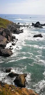 Rugged cliffs and ocean waves under a blue sky.