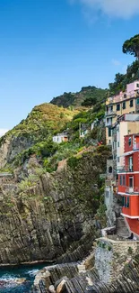 Colorful cliffside village scene overlooking the ocean.