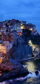 Scenic coastal village at night with vibrant lights and ocean view.