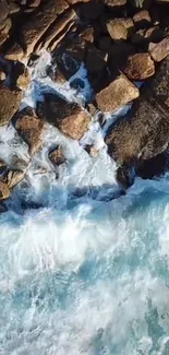 Aerial view of ocean waves crashing on rocks.