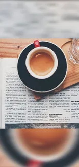 Espresso cup on newspaper with glass on wooden table.