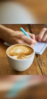 Cozy scene with coffee and notebook on a wooden table.