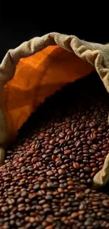 Rustic coffee beans in burlap sack spilling out.