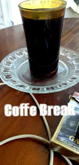 Iced coffee glass on a rustic wooden table with cozy decor elements.