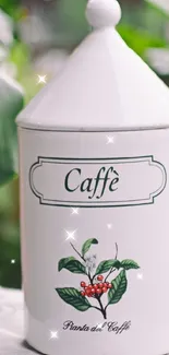 Ceramic coffee canister surrounded by green plants.