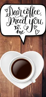 Heart-shaped coffee cup on wooden background.