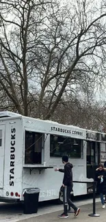 Starbucks coffee truck in a winter park scene.