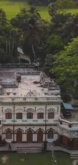 Aerial view of a colonial mansion surrounded by lush greenery.