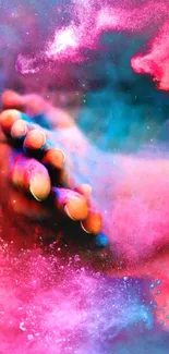 Vivid abstract hand with splashes of pink, blue, and red colors.