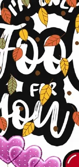 Autumn-themed wallpaper with colorful leaves and hearts on black background.