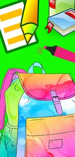 Colorful backpack and school supplies on green background.