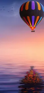 Colorful hot air balloon at sunset over reflective waters.